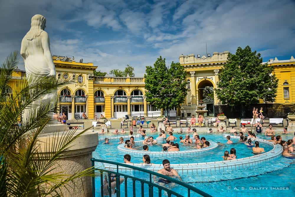 image of the outside pool with people swimming at the Szechenyi Baths in Budapest image of the outside pool with people swimming at the Szechenyi Baths in Budapest